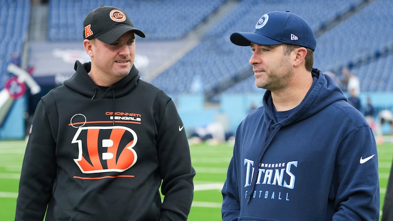 Cincinnati Bengals head coach Zac Taylor, left, talks with Tennessee Titans head coach Brian...