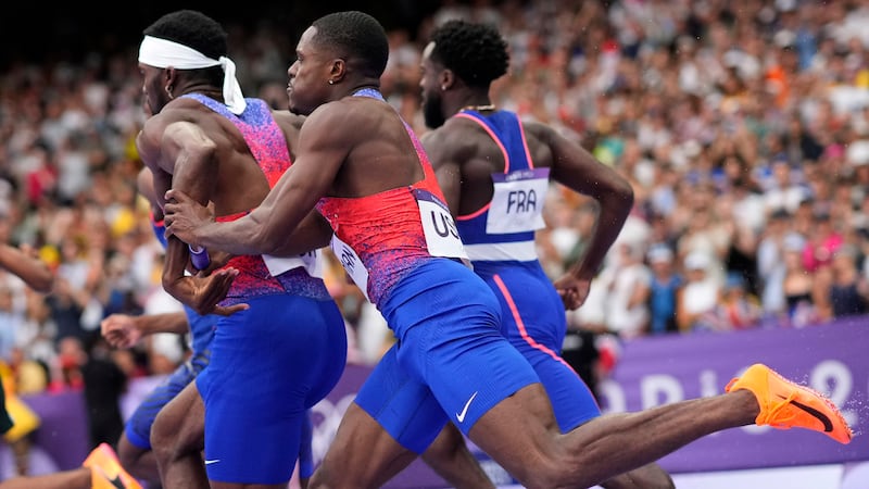 Christian Coleman, right, of the United States, struggles to hand the baton to teammate...