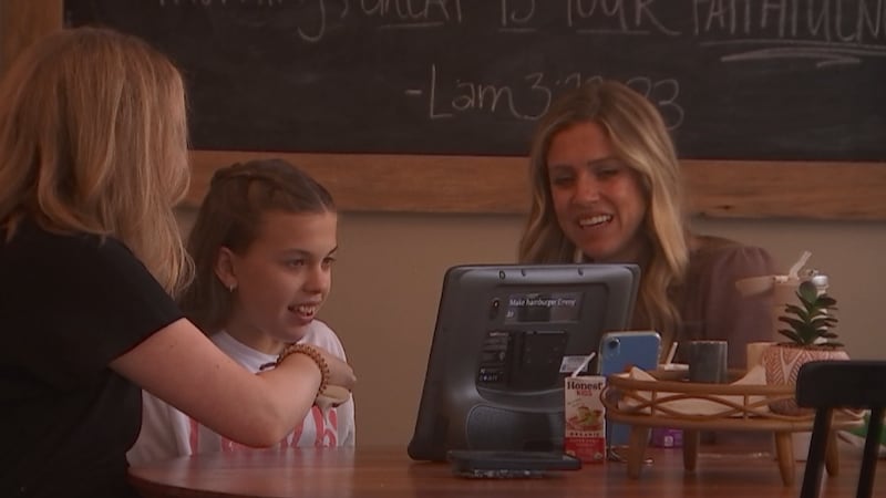 13-year old Blakely Goodman (middle) works with a speech therapist to help her communicate...