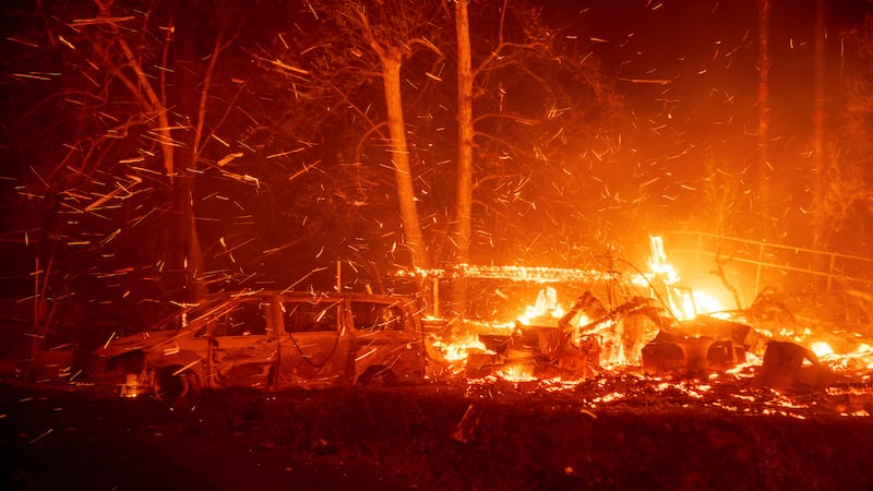 The Eaton Fire burns vehicles and structures Wednesday, Jan. 8, 2025 in Altadena, Calif. (AP...