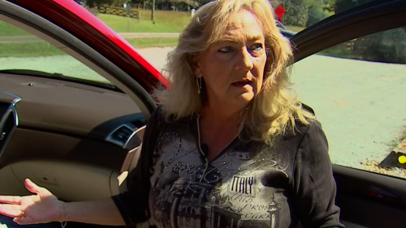 Angie Blankenship stands in front of her SUV that a court ordered she have outfitted with an...