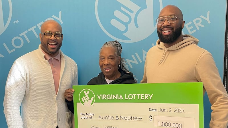 Virginia Lottery Executive Director Khalid Jones (left) presents the $1 million check to...