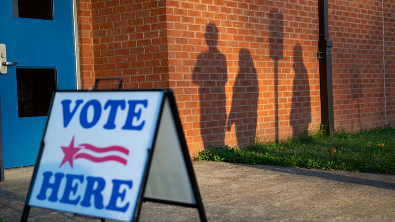 Voters wait outside the Lee Hill polling location on Election Day in Spotsylvania, Va., Nov....