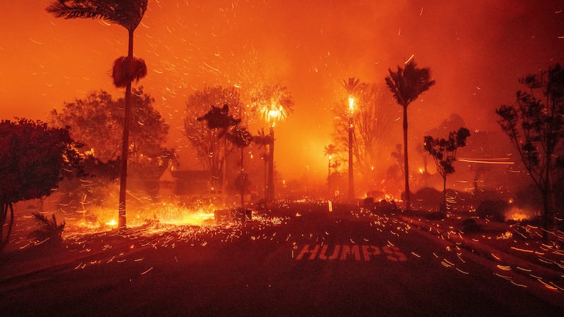 The Palisades Fire ravages a neighborhood amid high winds in the Pacific Palisades...