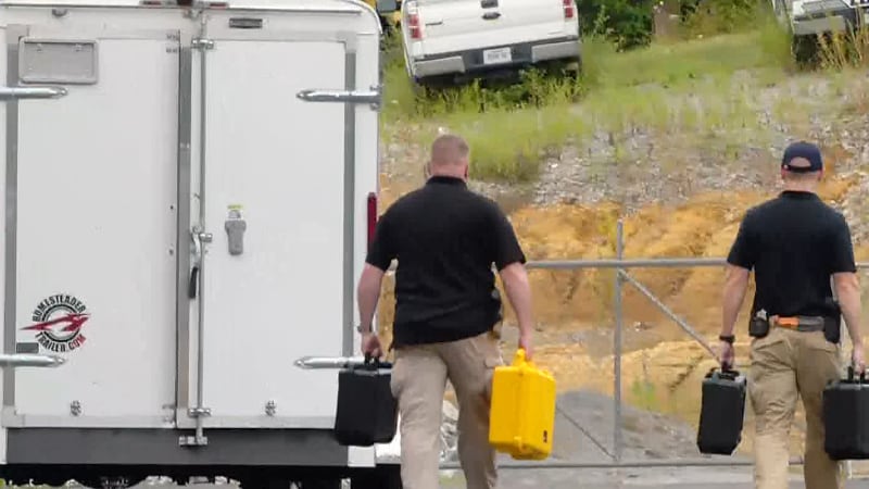 TBI Agents carry cases of evidence out of Millersville police headquarters.