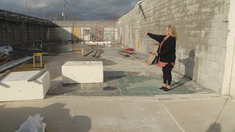 The owner of Miss Ellaneous in Hendersonville looks on at the rebuild after an EF-2 tornado...