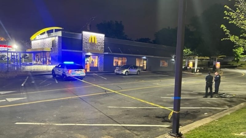 Detectives investigate a shooting that ended in a carjacking at a McDonald's parking lot in...