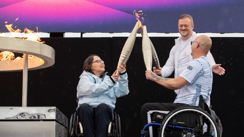 FILE - British Paralympians Helene Raynsford and Gregor Ewan light the Paralympic Flame in...