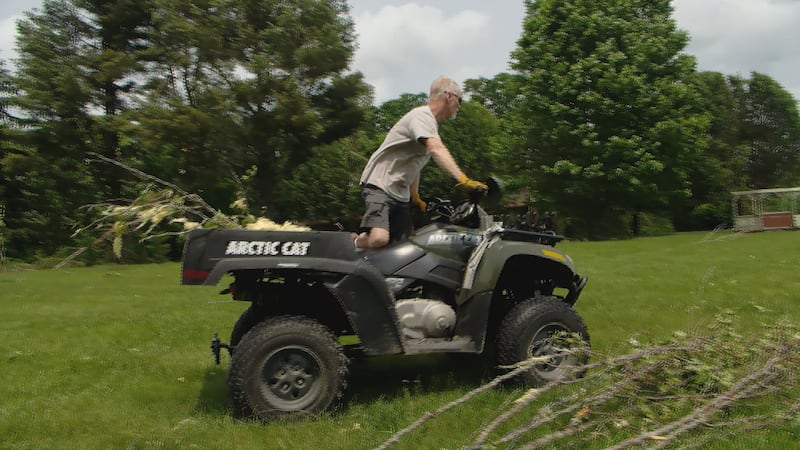 Rick Pedersen works to clear his property after a tornado touched down near his Smithville home.