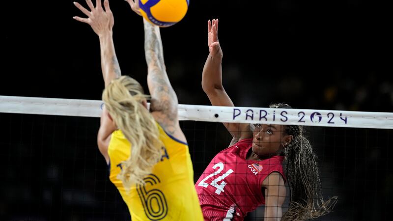 United States' Chiaka Ogbogu (24) hits the ball past Brazil's Thaisa Daher (6) during a...