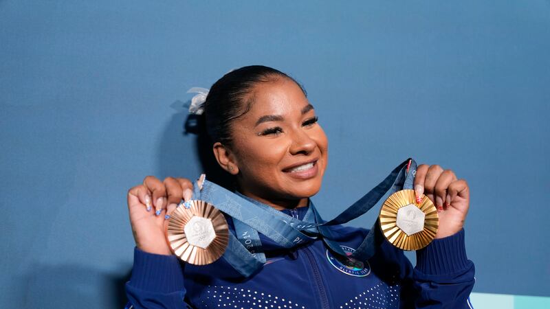 Jordan Chiles, of the United States, holds up her medals after the women's artistic gymnastics...