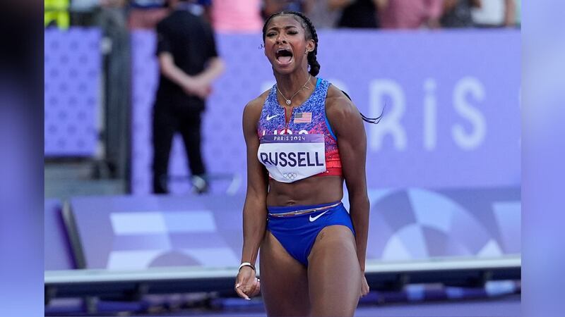 Masai Russell, of the United States, reacts after winning the women's 100-meter hurdles final...