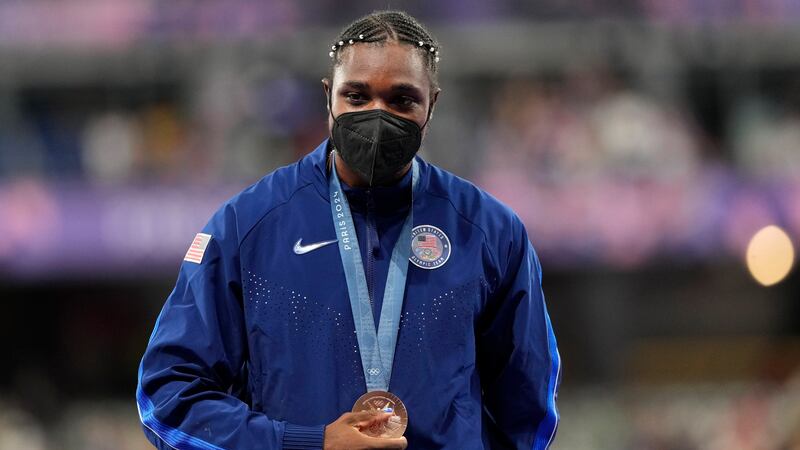 Men's 200-meter bronze medalist, Noah Lyles, of the United States, stands on the podium at the...