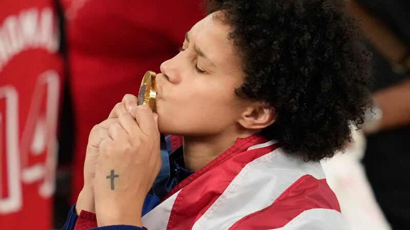 United States' Brittney Griner kisses her gold medal at Bercy Arena at the 2024 Summer...