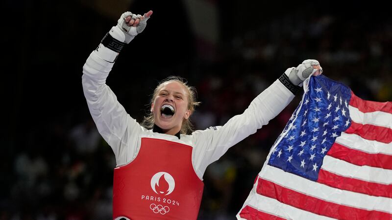 United States' Kristina Teachout celebrates after winning the women's 67kg Taekwondo bronze...