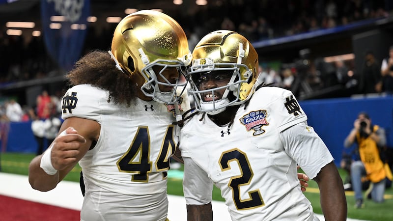 Notre Dame's Jayden Harrison (2) celebrates with teammate Junior Tuihalamaka (44) after...