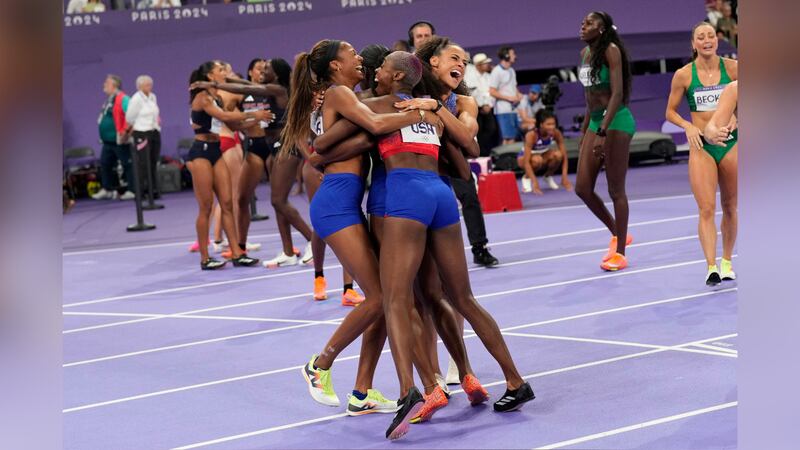 The United States' women 4x400-meter relay team celebrate winning the gold medal at the 2024...