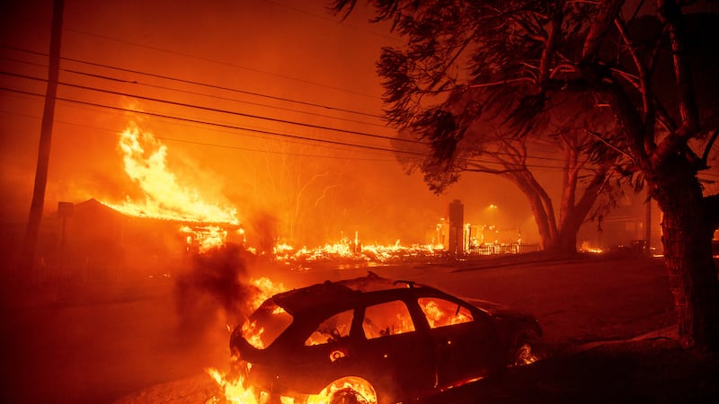 The Palisades Fire burns vehicles and structures in the Pacific Palisades neighborhood of Los...